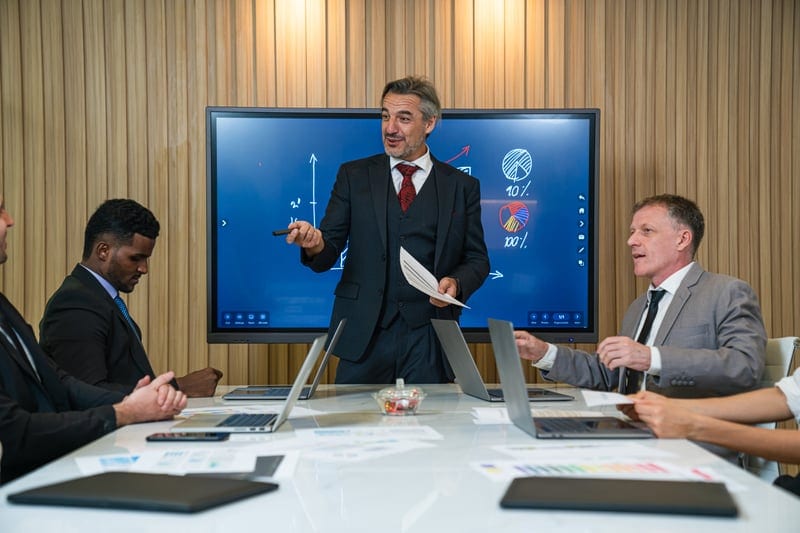 Governance team reviewing AI assessment evidence and DPIA records on a meeting-room screen.