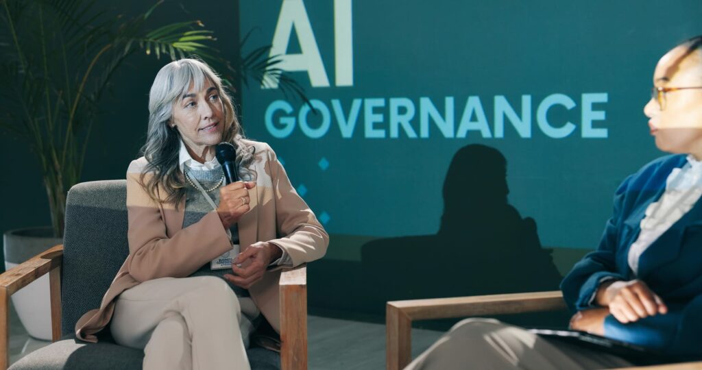 Business conference presentation on AI governance and organisational roles.