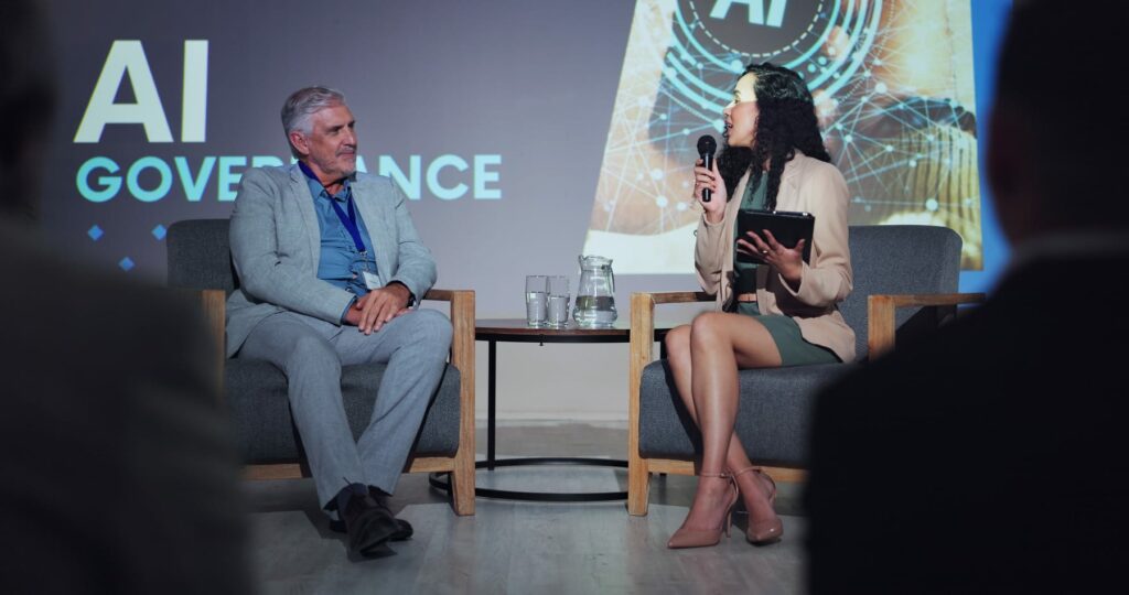 AI governance discussion with a speaker and audience, supporting bias, fairness and explainability review.