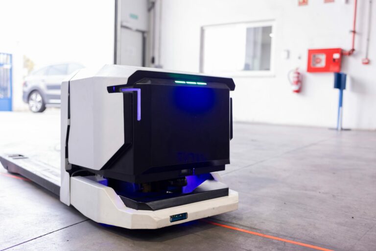 Autonomous mobile robot transporting goods through a warehouse