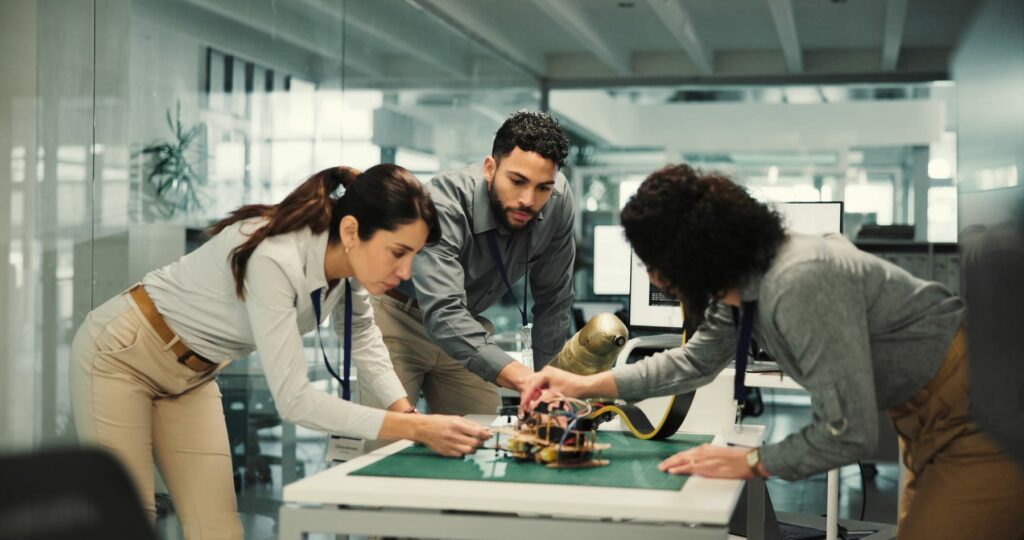 Cross-functional team reviewing a robotics system and its operational evidence